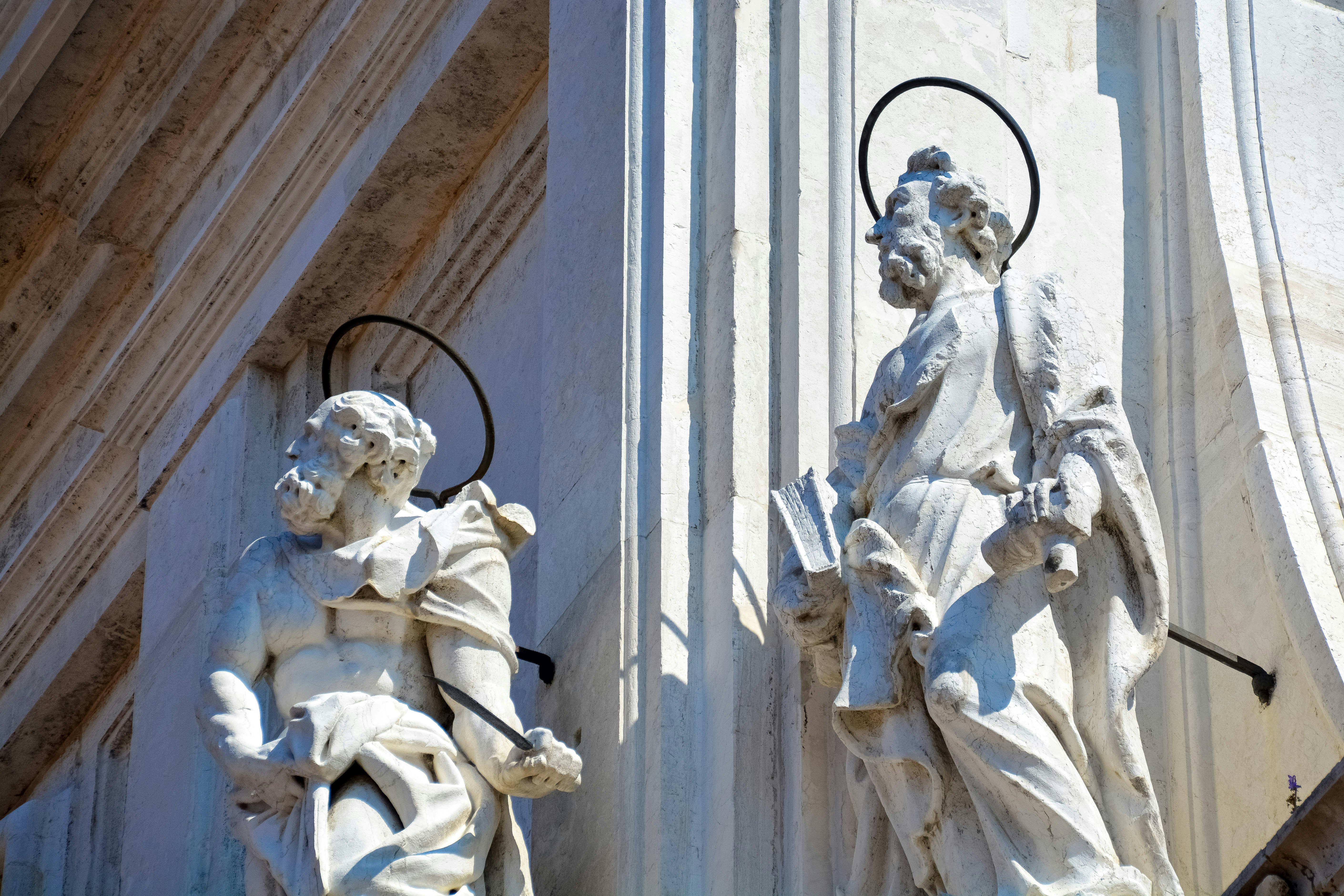 white concrete statue of man and woman